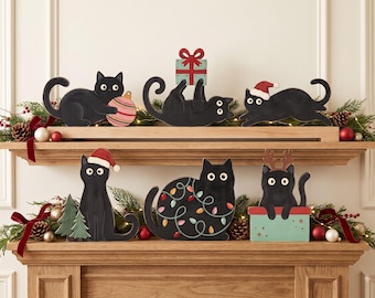 May include: A set of six black cat figurines featuring various holiday themes, including a cat with a striped ornament, a cat holding a gift, a cat in a Santa hat, a cat with Christmas lights, and a cat in a box with reindeer antlers.