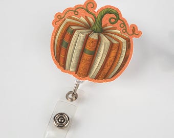 Carrete de insignias con forma de libro de calabaza: soporte para identificación de maestro de otoño, clip para insignia de bibliotecario, lindo carrete retráctil, regalo de trabajo de otoño para amantes de los libros y compañeros de trabajo.