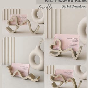 May include: A collection of beige business card holders in various designs, each holding a pink business card. The holders have unique, flowing shapes. The text "business card holder" and "STL + BAMBU FILES" are visible.