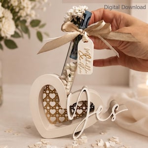 May include: A heart-shaped gift with the word "Yes" and a bottle filled with heart-shaped sweets. The bottle is adorned with a ribbon and a tag. The text "heart gift" and "STL + BAMBU FILES" are visible.
