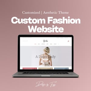May include: A laptop computer displaying a website for a fashion brand called "Zerba". The website features a model wearing a white dress with the text "A Daisy Lady" and "Zerba Clothing" on the screen.