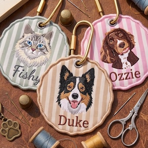 Puede incluir: Tres parches bordados circulares con bordes festoneados y mosquetones dorados. Cada parche presenta el retrato de una mascota y un nombre: un gato llamado Fishy sobre rayas salvia, un perro llamado Duke sobre rayas beige y Ozzie sobre rosa.
