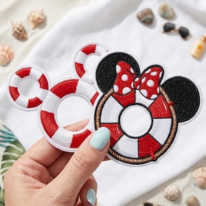 May include: Two embroidered patches featuring a red and white striped life preserver design. One patch includes black mouse ears and a red bow with white polka dots. The patches are circular with a central hole and a rope-like border detail.