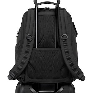May include: A black backpack with a telescoping handle, attached to a rolling suitcase. The backpack has padded shoulder straps, multiple compartments, and a mesh back panel for ventilation. The handle is extended, ready for travel.
