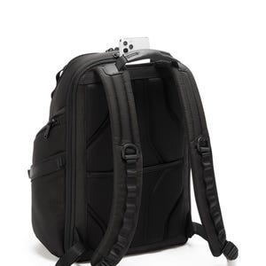 May include: Black backpack with padded shoulder straps and a mesh back panel. A smartphone rests in the top handle. The backpack has multiple compartments and a sleek, modern design, suitable for travel or everyday use.