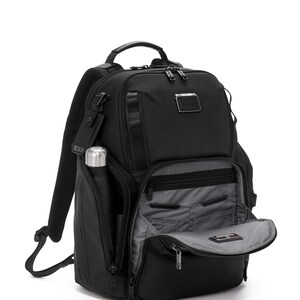 May include: Black backpack with multiple compartments, a top handle, and adjustable shoulder straps. Features a side pocket with a silver water bottle and an open front compartment revealing interior pockets. The backpack has a sleek, modern design.