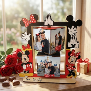 May include: A wooden photo frame featuring Mickey and Minnie Mouse designs. The frame is red and black, with a rotating cube for displaying photos. The base is engraved with the names "Alex & Lily".