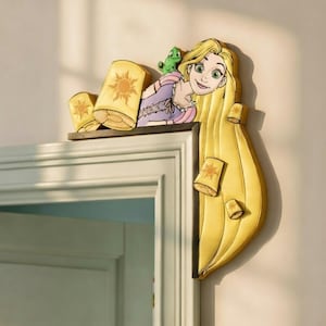 May include: A wooden decorative piece featuring a cartoon of a blonde woman with long hair, a green chameleon, and several yellow lanterns with sun designs. The piece is designed to be placed on a door frame.