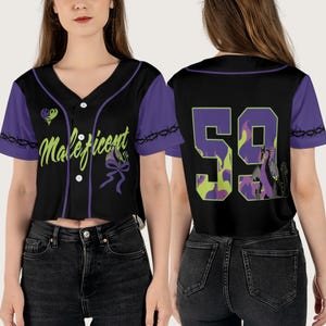 May include: A black baseball jersey with purple trim and a green and purple design. The front of the jersey has the word "Maleficent" in green letters with a purple heart and a purple bow. The back of the jersey has the number "59" in purple and green with a purple dragon.