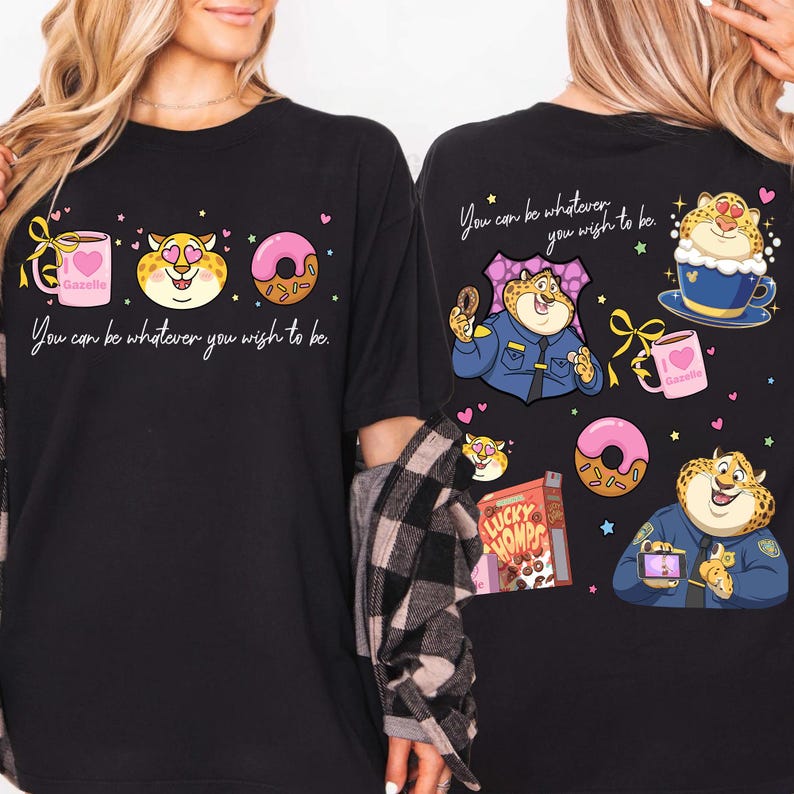 May include: Black t-shirt with a cartoon design featuring a cheetah character, donuts, and coffee. The text "You can be whatever you wish to be" is printed on the front. The back of the shirt has a similar design.
