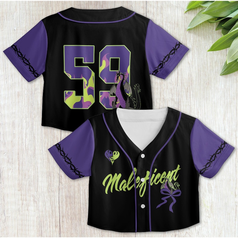 May include: Two black and purple baseball jerseys with a dragon and the word "Maleficent" printed on them. The jersey on the left has the number "59" printed on the back.