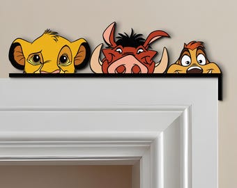 May include: A decorative door frame topper featuring Simba, Pumbaa, and Timon from The Lion King. The characters are in vibrant colors, with a black border. The topper is designed to sit above a door frame, adding a touch of Disney charm.