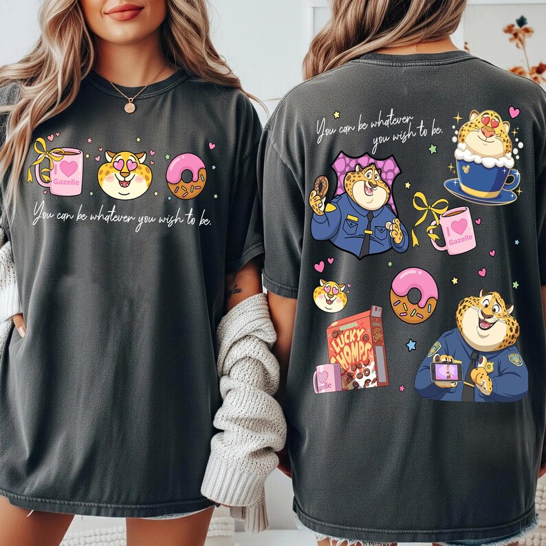 May include: Dark gray t-shirts with a cartoon design featuring a cheetah character, donuts, coffee, and the text "You can be whatever you wish to be." The design is repeated on the front and back.