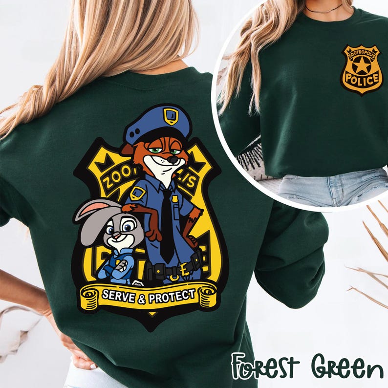 May include: Forest green sweatshirt with a Zootropolis police badge on the front and a large graphic on the back. The back graphic features Nick Wilde and Judy Hopps in police uniforms, with the words "Zootropolis Police" and "Serve & Protect".