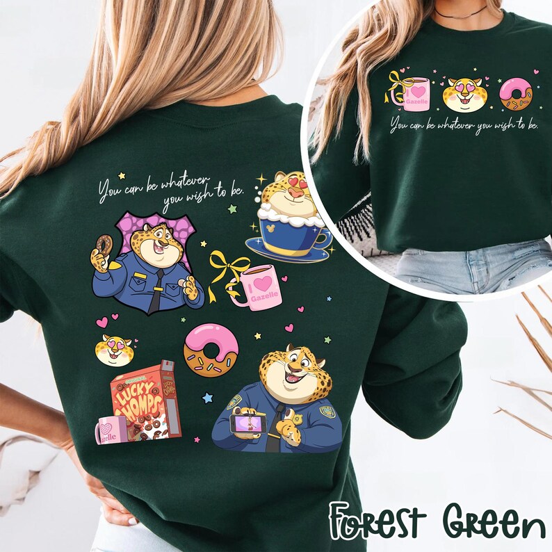 May include: Forest green sweatshirt featuring cartoon cheetah illustrations with donuts, coffee, and cereal. Text reads "You can be whatever you wish to be." The design includes the text "Gazelle" on a mug.
