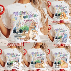 May include: White t-shirts with colourful graphics featuring the text "Mother Daughter Trip" and Disney characters. Designs include a kangaroo, Lady and the Tramp, Dumbo, Belle and Chip, Bambi, and Simba.