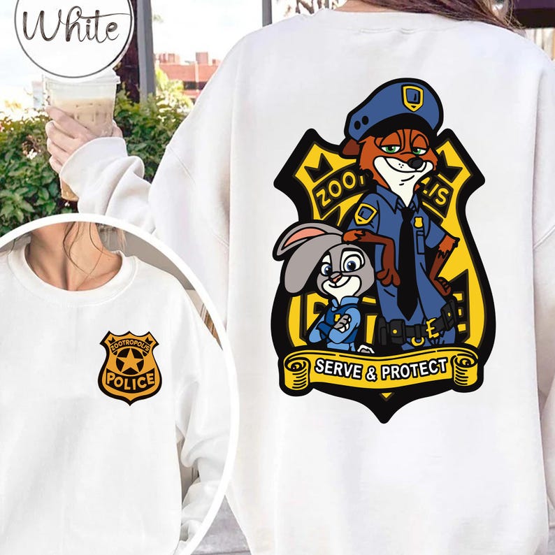 May include: White sweatshirt with a Zootropolis police badge on the front and a larger graphic on the back. The back graphic shows Nick Wilde and Judy Hopps in police uniforms, with the text "SERVE & PROTECT".