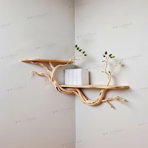 May include: A unique, natural wood corner shelf designed to resemble a tree. The shelf features two circular platforms connected by a sculpted, branch-like structure. Small green leaves adorn the ends of the branches. A stack of white items rests on the lower shelf.