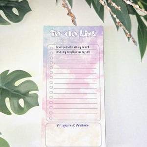 May include: A pastel-colored To-Do List notepad with the text "To-Do List" at the top. The notepad includes sections for a date, a checklist with lines, and a section for "Prayers & Praises". The notepad has a watercolor-like design.