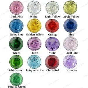 May include: A collection of seventeen round faceted gemstones arranged in a grid, each labeled with its color name including Dark Pink, White, Light Yellow, Apple Yellow, Rolay Blue, Golden Yellow, Orange, Blue, Green, Rose, Violet, Light Pink, Light Green, L-Aquamarine, China Red, Lavender, and Paraiba Green.