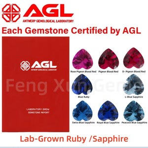 May include: A close-up of a red and white label with the text "AGL Antwerp Gemological Laboratory" and the text "Each Gemstone Certified by AGL". Below the label are nine heart-shaped gemstones in various shades of red and blue. The gemstones are labeled with names such as "Rose Pigeon Blood Red", "Pigeon Blood Red", "D-Pigeon Blood Red", "Blue Ruby", "L-Blue Sapphire", "Swiss Blue Sapphire", "Royal Blue Sapphire", and "Peacock Blue Sapphire". The text "Lab-Grown Ruby / Sapphire" is at the bottom of the image.