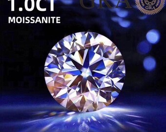 May include: A large, clear, round, faceted gemstone with a brilliant sparkle. The gemstone is a 1.0 carat moissanite with a D color and VVS1 clarity. The gemstone is certified by the Gemological Research Academy (GRA).