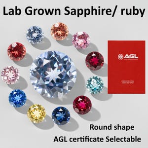 May include: An assortment of round-shaped lab-grown sapphires and rubies in various colors, including blue, pink, and red. A red AGL certificate is visible. The image includes the text "Lab Grown Sapphire/ ruby" and "Round shape".