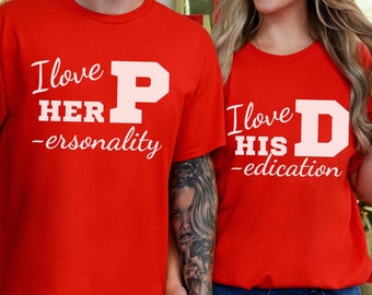 Puede incluir: Dos camisetas rojas con un estampado gráfico blanco. El texto en las camisetas dice "Me encanta su -ersonality" y "Me encanta su -ducation".