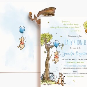 May include: Watercolor baby shower invitation featuring Winnie the Pooh characters. The invitation includes a blue balloon, a tree, and the text "Baby Shower" with event details. The design has a soft, whimsical aesthetic.