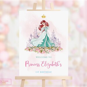 May include: A white ceramic mug with a black handle and the text "But First, Coffee" in a handwritten style. The mug is on a white surface. The mug is approximately 10 cm tall.