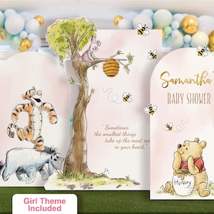 Winnie the Pooh baby shower standee set in a soft pink girl theme. Features personalized name panel, Tigger and Eeyore character cutout, and Piglet on a tree with honey bees and the quote 'Sometimes the smallest things take up the most room in your heart.' Perfect for a whimsical baby shower backdrop.