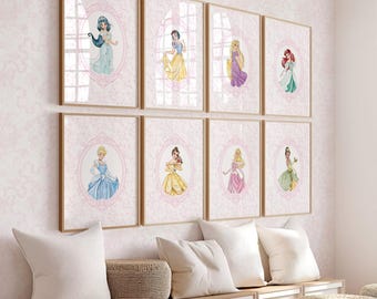 May include: Eight framed watercolor prints of Disney princesses, each in a decorative oval frame. The princesses are depicted in their iconic gowns, with a pink floral background. The frames are a light wood color, and the overall theme is a fairytale aesthetic.