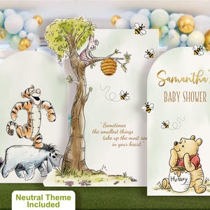 Gender neutral Winnie the Pooh baby shower backdrop set featuring soft neutral tones. Includes custom name panel, playful character cutouts of Tigger, Eeyore, and Piglet on a tree with buzzing bees and the quote 'A little hunny is on the way'. Perfect for a unisex baby shower decoration.