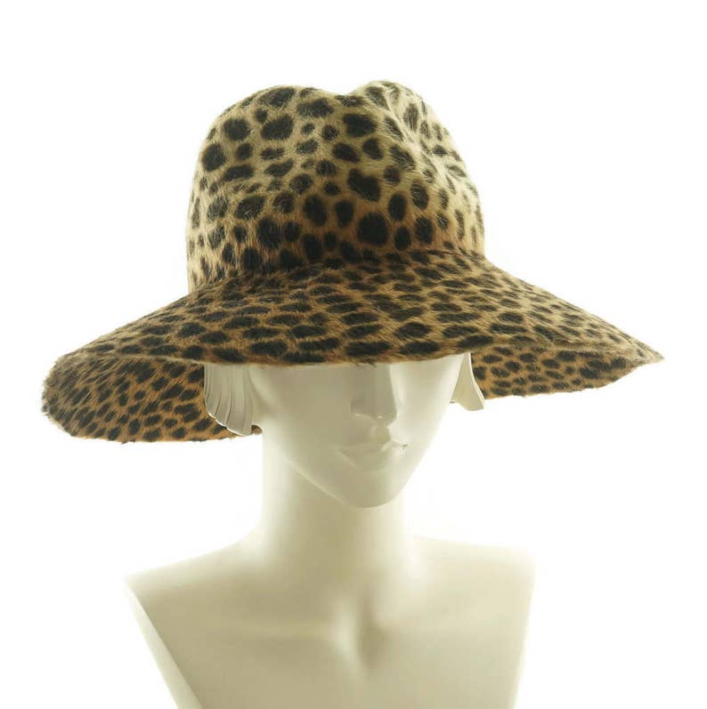 May include: A wide-brimmed hat with a leopard print pattern. The hat is made of a soft, furry material and has a wide, floppy brim.