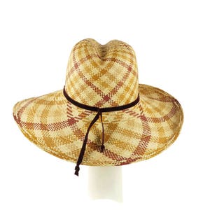 May include: A wide-brimmed straw hat with a brown plaid pattern and a brown velvet ribbon.