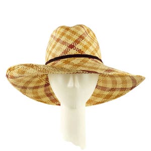 May include: A wide-brimmed straw hat with a checkered pattern in shades of brown and red. The hat has a brown velvet band around the crown.
