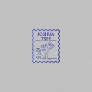 May include: A blue postage stamp design featuring a Joshua Tree illustration. The stamp has a scalloped border and the words "JOSHUA TREE" at the top. The image includes a Joshua Tree and a rock formation.