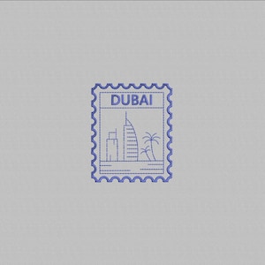 May include: A blue postage stamp design featuring the word "DUBAI" at the top. The stamp depicts a stylized cityscape with buildings and palm trees. The stamp has a decorative, scalloped border.