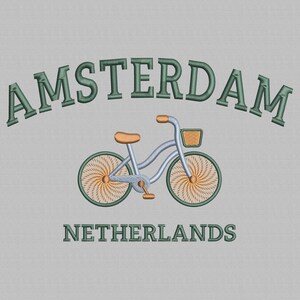 May include: A green embroidered design of a bicycle with a basket on a gray background. The text "AMSTERDAM" and "NETHERLANDS" is also embroidered in green.
