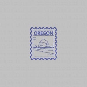 May include: A blue embroidered stamp featuring the word "OREGON" at the top. The stamp design includes a mountain and coastline scene. The stamp has a scalloped edge and is set against a light gray background.