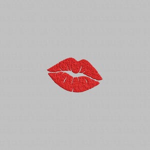 May include: A red embroidered image of a pair of lips on a light gray background. The lips are full and detailed, with visible stitching creating texture. The design is simple and bold, suitable for various applications.