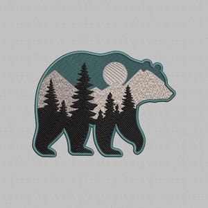 May include: Embroidered patch in the shape of a bear, with a teal outline. The bear's interior features a mountain and forest scene with a full moon. The mountains are light grey, the trees are black, and the sky is teal.