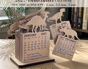 May include: A wooden 2027 dinosaur calendar with laser-cut dinosaur silhouettes. The calendar features monthly pages with dates, including January and December, and text indicating 3 mm, 3.2 mm, and 4 mm material thickness options for laser cutting.