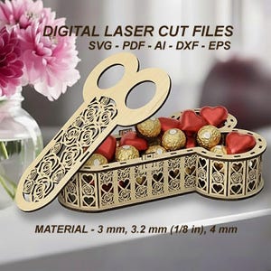 Puede incluir: Un recipiente de madera cortado con láser en forma de llave, lleno de bombones. El diseño de la llave presenta cortes de rosas y corazones, con el texto "DIGITAL LASER CUT FILES". El material es de 3 mm, 3,2 mm (1/8 pulg) y 4 mm.