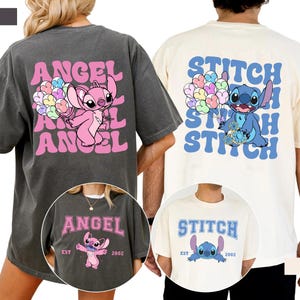 Puede incluir: Dos camisetas holgadas, una color pimienta y otra marfil, con personajes de dibujos animados. La camiseta color pimienta muestra "ANGEL" en rosa con un personaje rosa sosteniendo globos. La camiseta marfil muestra "STITCH" en azul con un personaje azul sosteniendo globos.