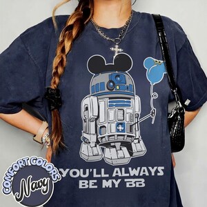 May include: Navy blue Comfort Colors t-shirt featuring a cartoon R2-D2 character with Mickey Mouse ears holding a blue balloon. The text "YOU'LL ALWAYS BE MY BB" is printed below the graphic.