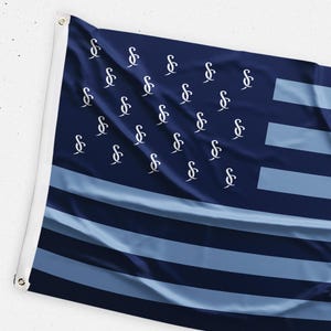 May include: A navy blue flag with a light blue and white design. The flag features a series of light blue stripes and a field of navy blue with white stylized letter "S" symbols.