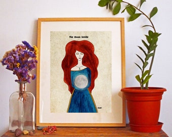 May include: A framed illustration of a woman with long red hair holding a moon in her hands. The text "The moon inside" is written above the woman. The background is a light beige color.