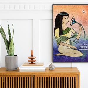 May include: A watercolor illustration of a woman with long black hair wearing a yellow and green dress, holding a blue and yellow lotus flower. The background is a gradient of orange, yellow, and purple. The text "Ancient scent of Man, whispers the lotus into my heart, in a soul's embrace." is written in the bottom right corner.