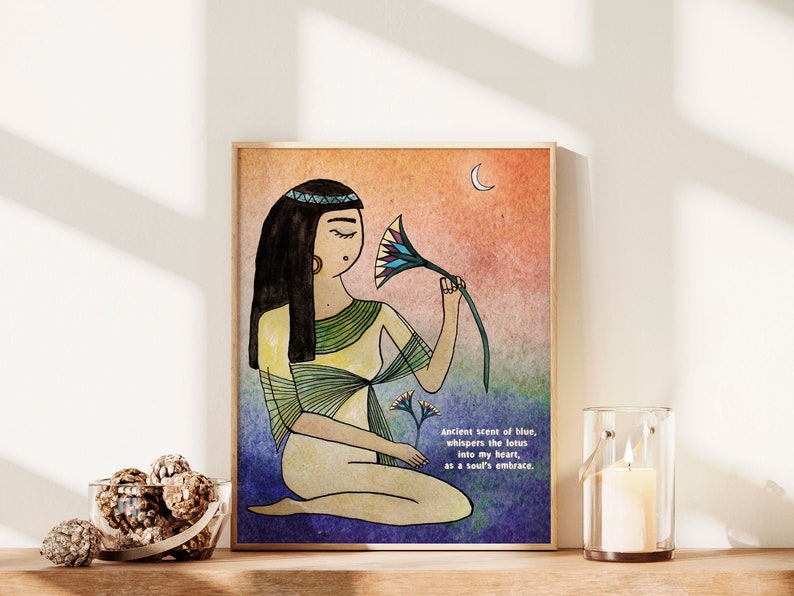May include: A watercolor illustration of a woman with long black hair wearing a yellow and green dress. She is holding a blue and green lotus flower and looking at it. The background is a watercolor wash of orange, pink, and blue. The text "Ancient scent of blue, whispers the lotus into my heart, as a soul's embrace." is written in black at the bottom of the image.